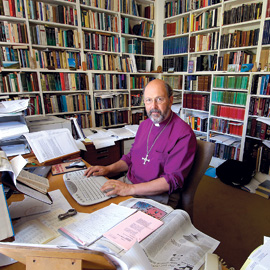 wright at his desk with books.jpg
